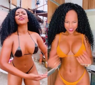 Hermosa morena con el pelo rizado bailando en bikini