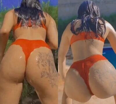 Mujer desnuda bailando en bragas junto a la piscina