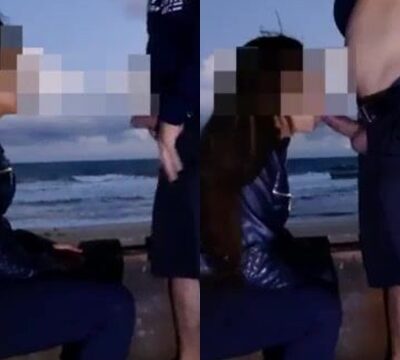 Mujer misteriosa chupando la polla de un hombre en la playa