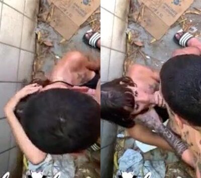 Mujer practicando sexo oral en el callejón